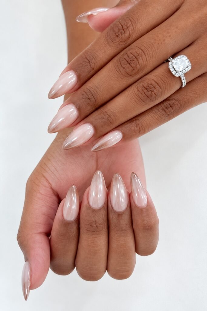 Champagne chrome almond nails with a diamond ring