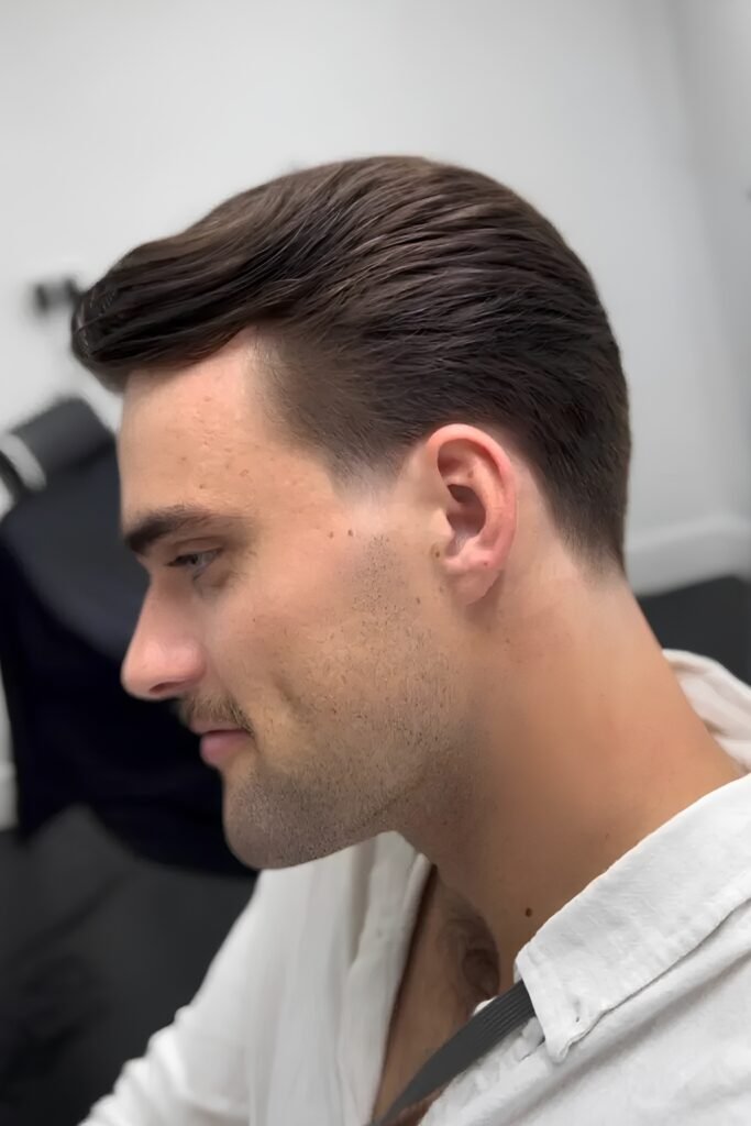Side view of a classic low taper with a combed top