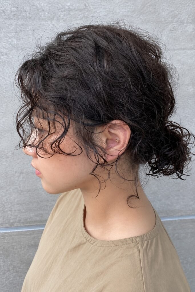 Side view of a curly messy bun