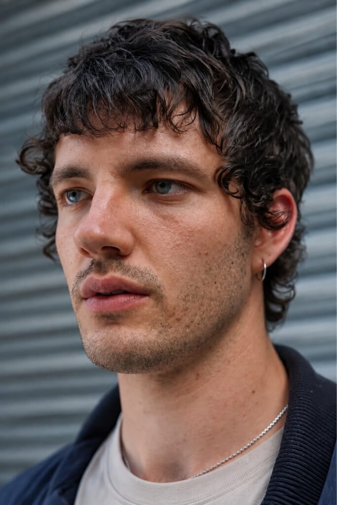 Man with a curly short shag
