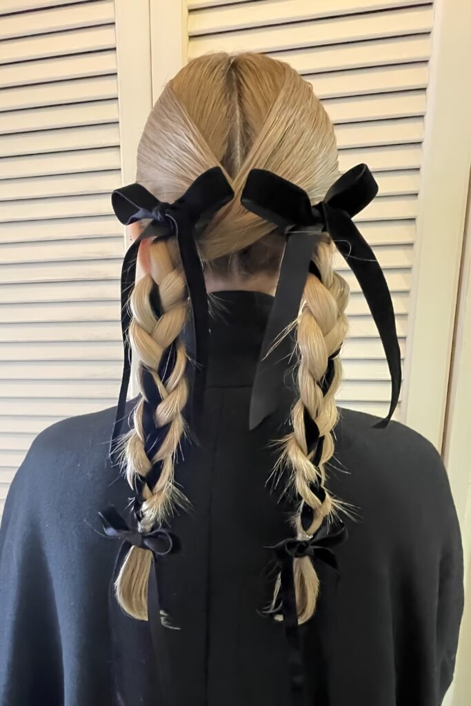Back view of double braids tied with black velvet ribbon