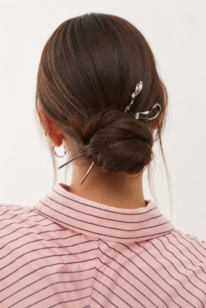 Back view of a low bun held with a French pin