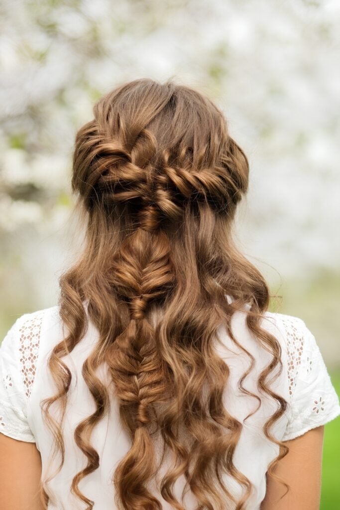 Back view of half-up side braids over long curls