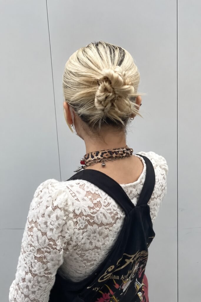 Back view of a blonde magpie bun with ends sticking out