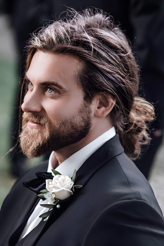 Low man bun with a shaped beard