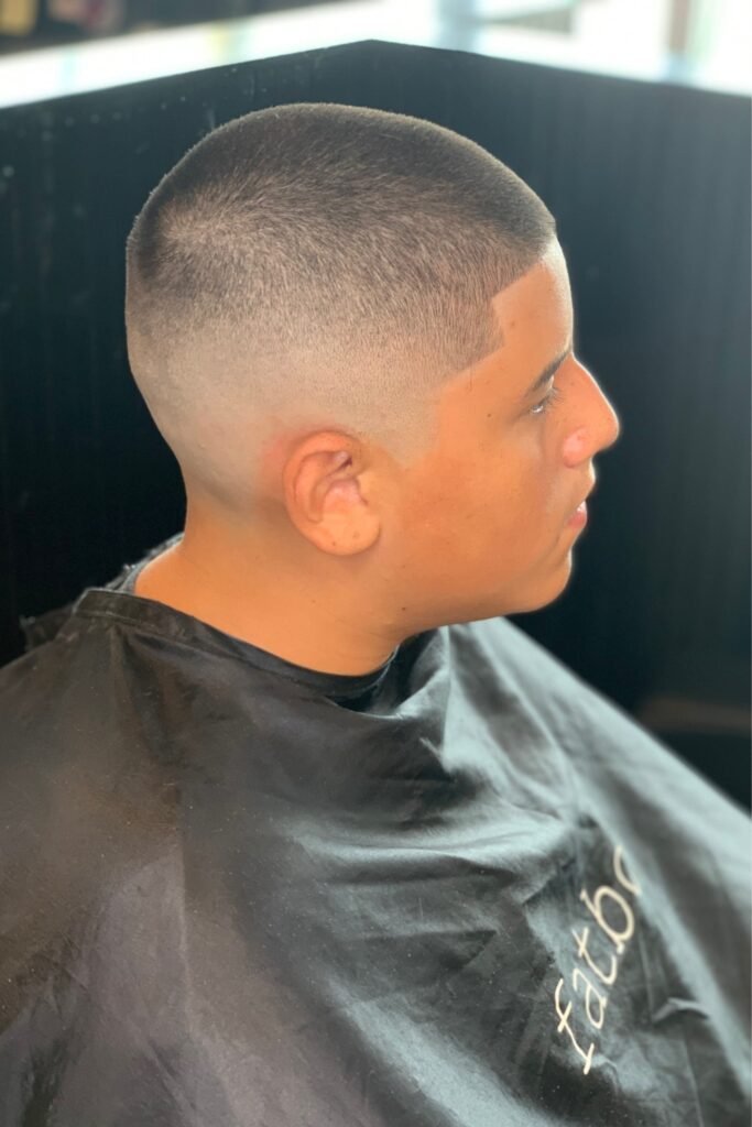 Very short military buzz cut with a skin fade, side view