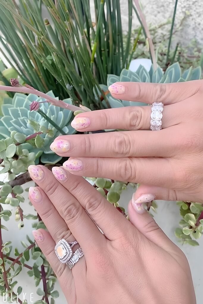Milk-bath floral nails with engagement rings among succulents