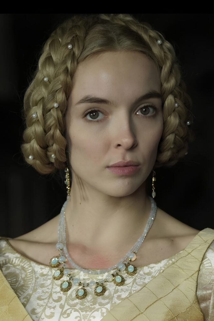 Coiled temple braids worn with a period dress