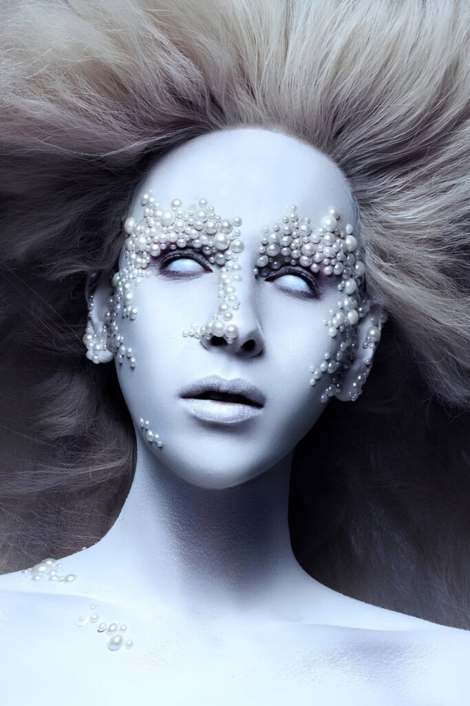 Editorial look with pale pearly skin, crystals around the eyes and silver hair