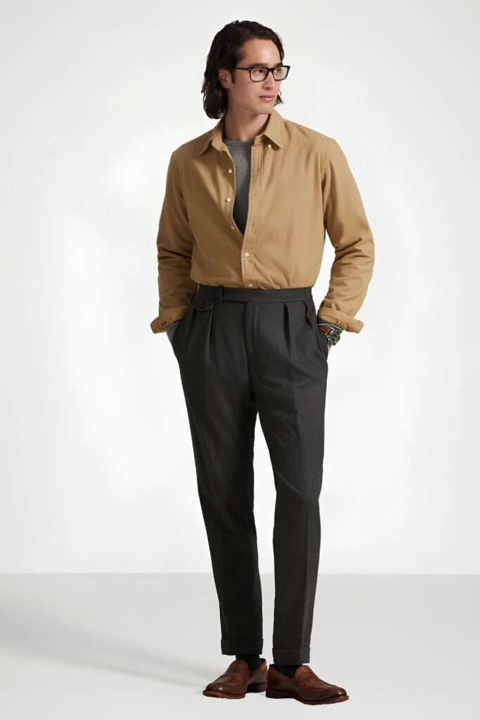 Man in a plain tan flannel shirt tucked into dark wool trousers with loafers