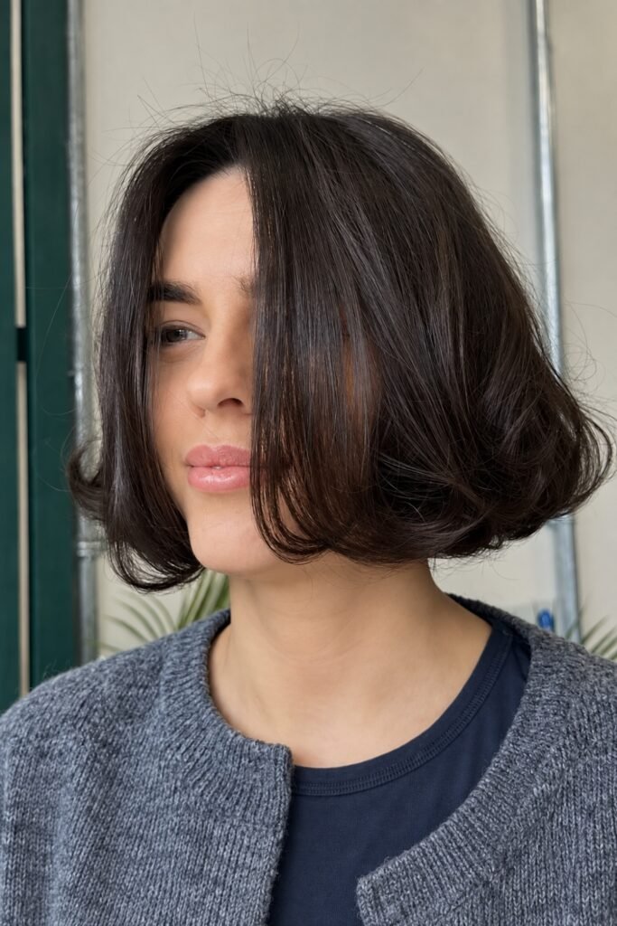 Woman with a dark rounded bob with subtle layers