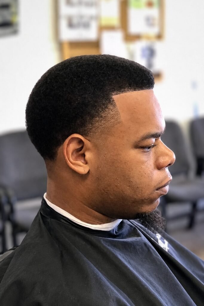 Side view of a short afro with tapered edges