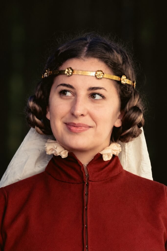 Dark curled bob with a gold circlet and sheer veil