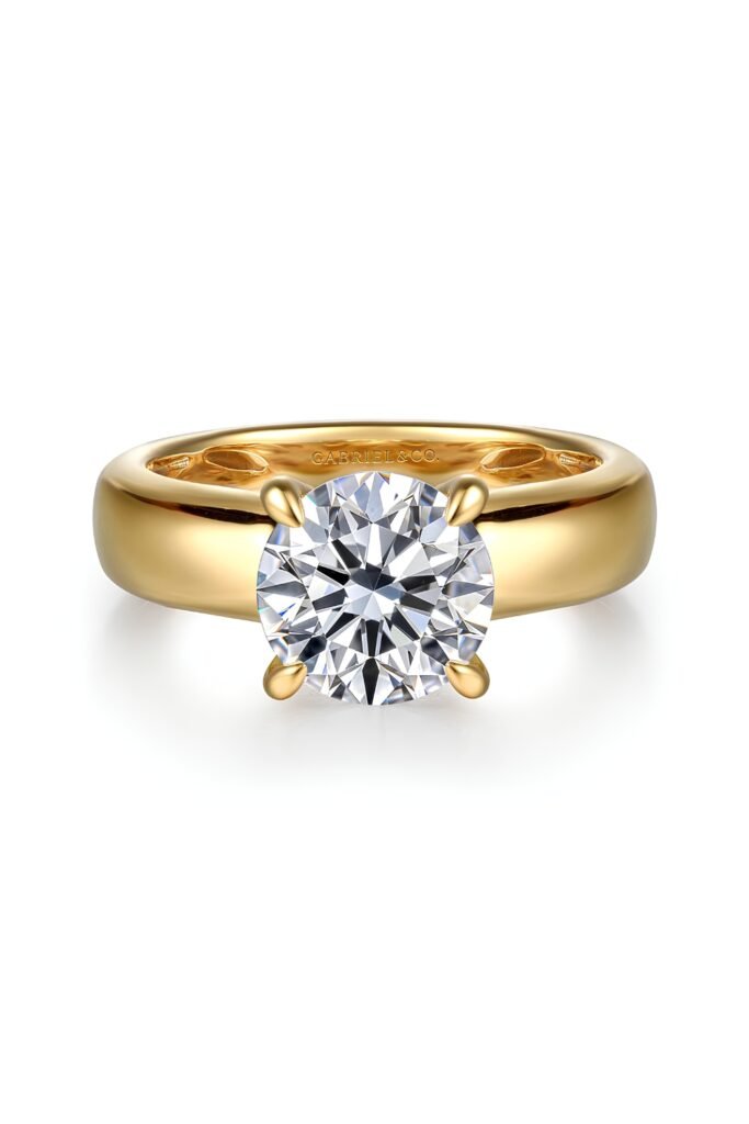 Wide gold band solitaire ring