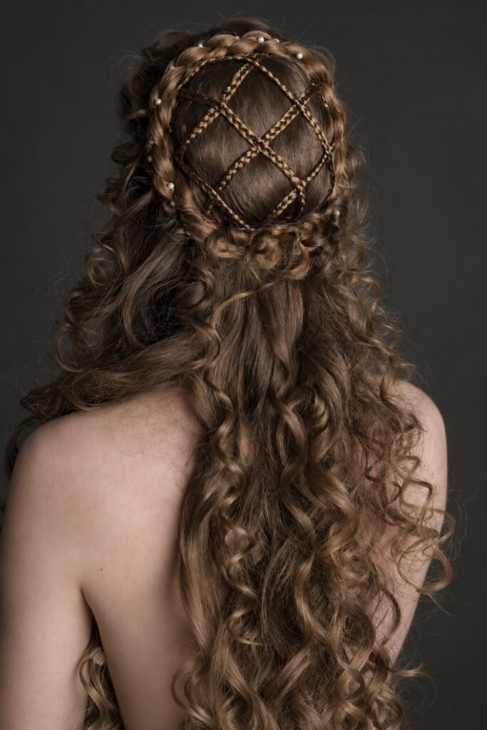 Back view of a woven lattice half-up style over curls