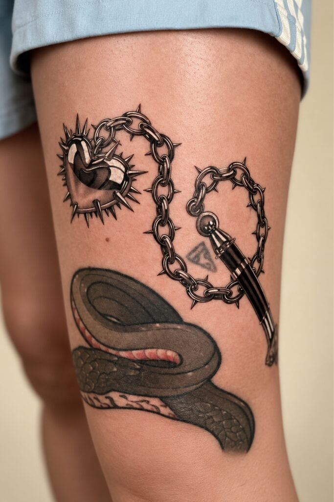 Barbed heart and chain tattoo