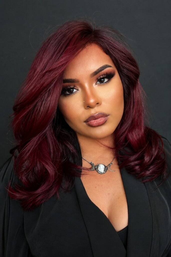 Dark cherry-red wavy hair with a glossy finish