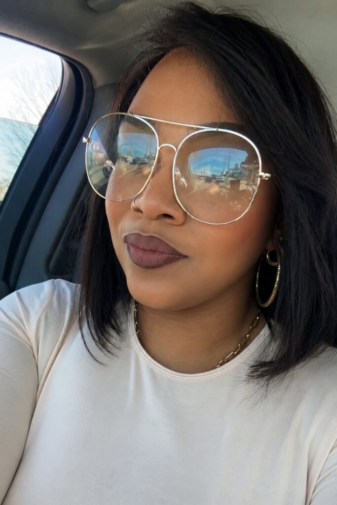 Woman in glasses wearing a blurred brown halo lip