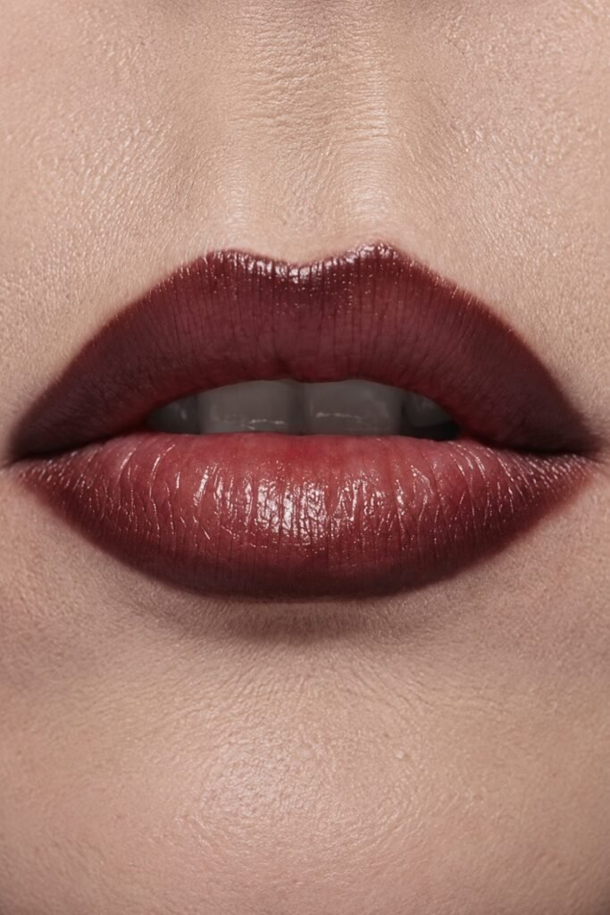 Close-up of lips defined with brown liner and a deep glossy center