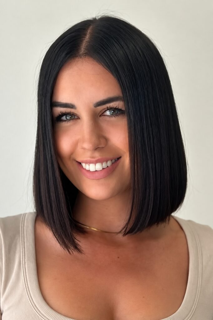 Woman with a center-part blunt lob in black