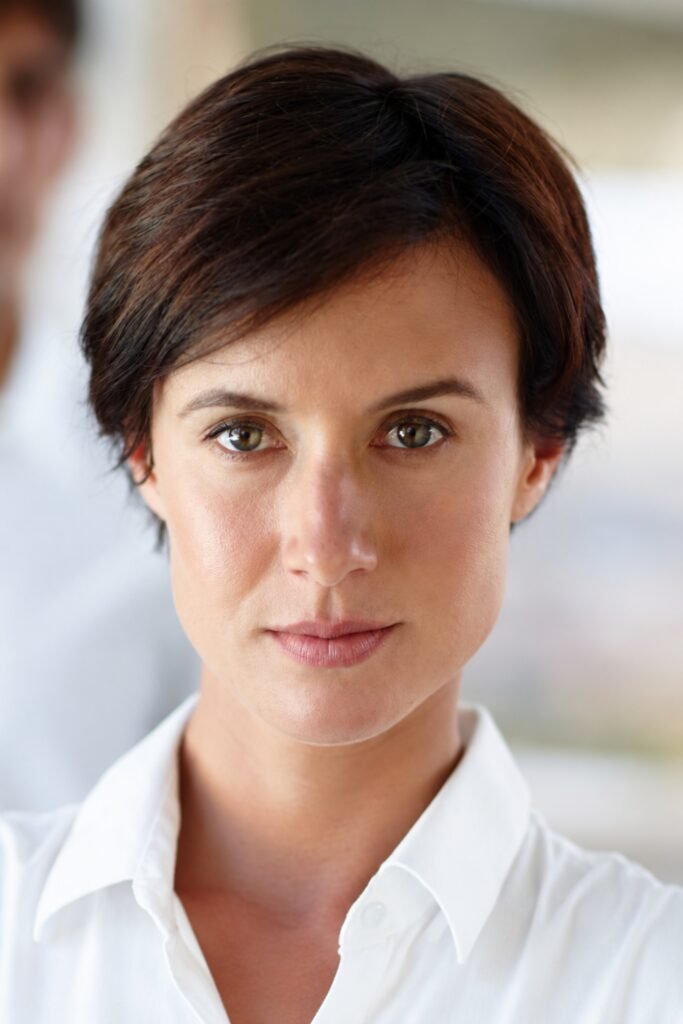 Woman with a classic tapered pixie in dark brown
