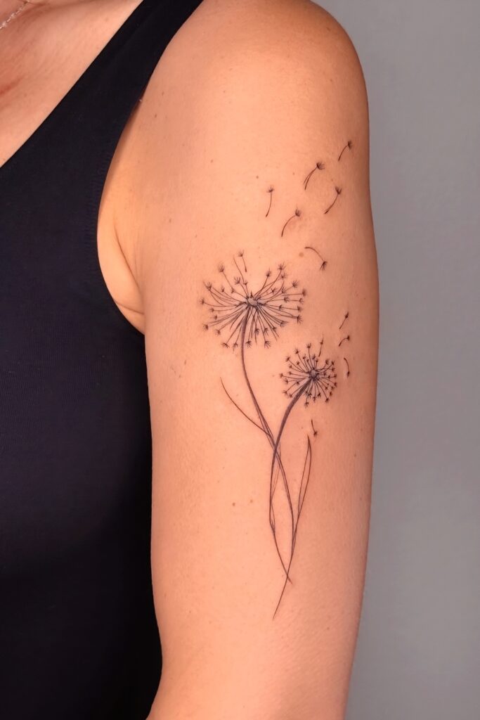 Dandelion with floating seeds tattoo