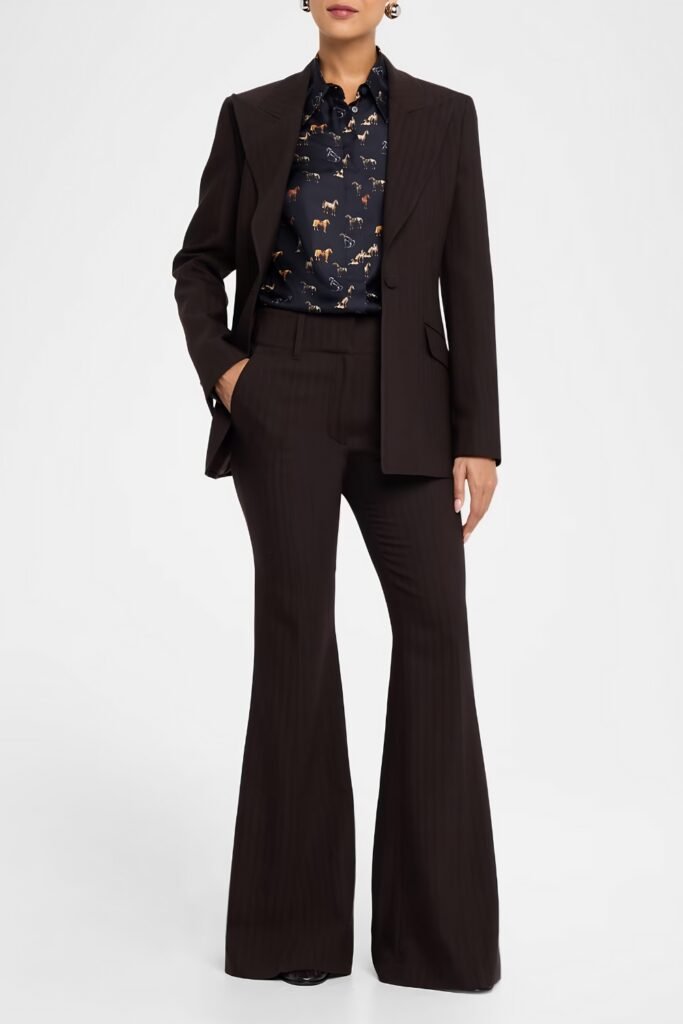 Woman in a dark brown equestrian-style suit with flared trousers