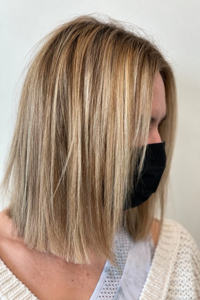 Side view of a fine-hair blunt lob with blonde highlights