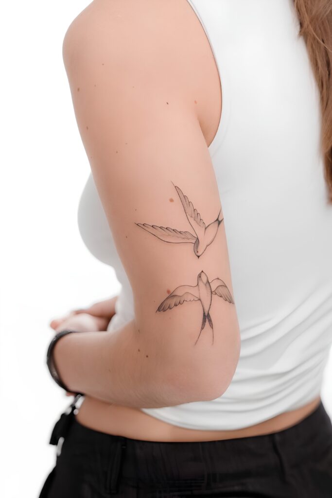 Fine-line crane tattoo