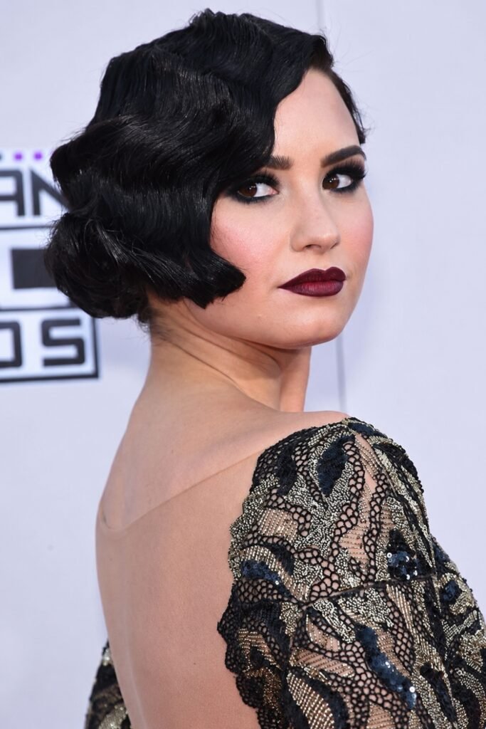Glossy black finger-wave bob with dark lips