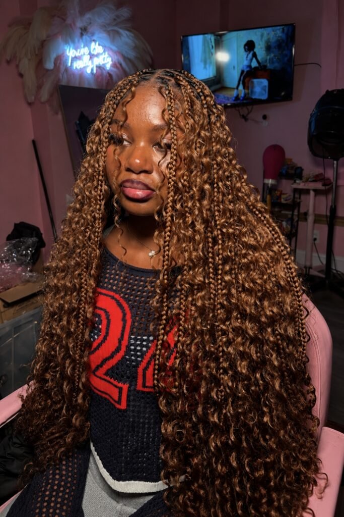 Long honey-brown goddess braids with loose curls