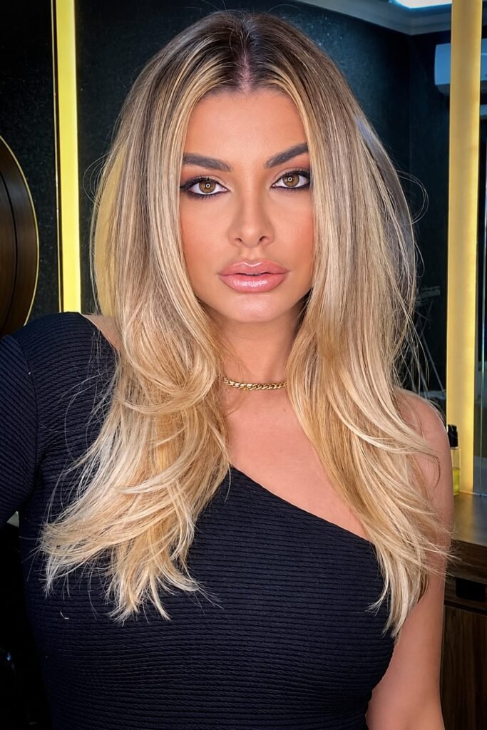Long blonde layers with rounded ends and a center part