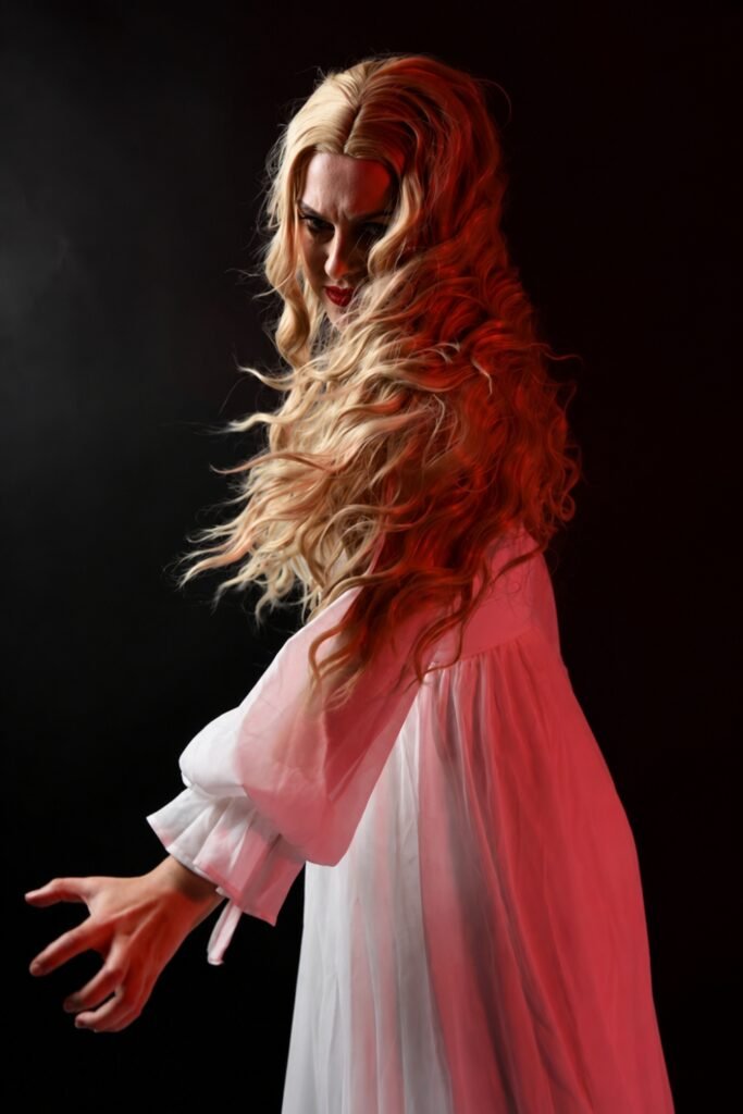 Long strawberry-blonde waves worn loose over a white gown