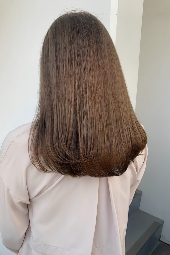Back view of straight light-to-medium brown hair in one even tone