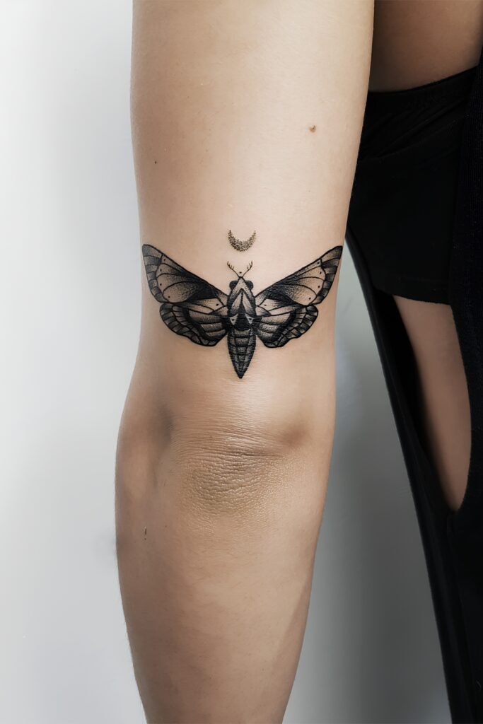 Moth and crescent moon tattoo