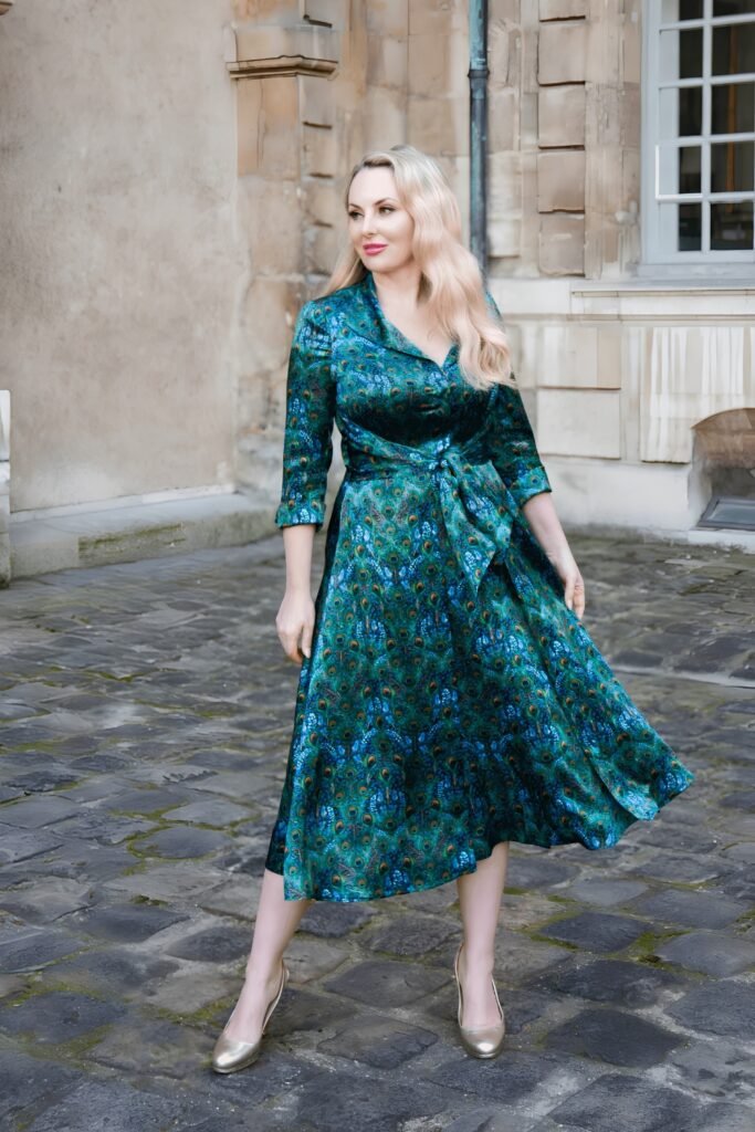 Woman in a peacock-green satin dress