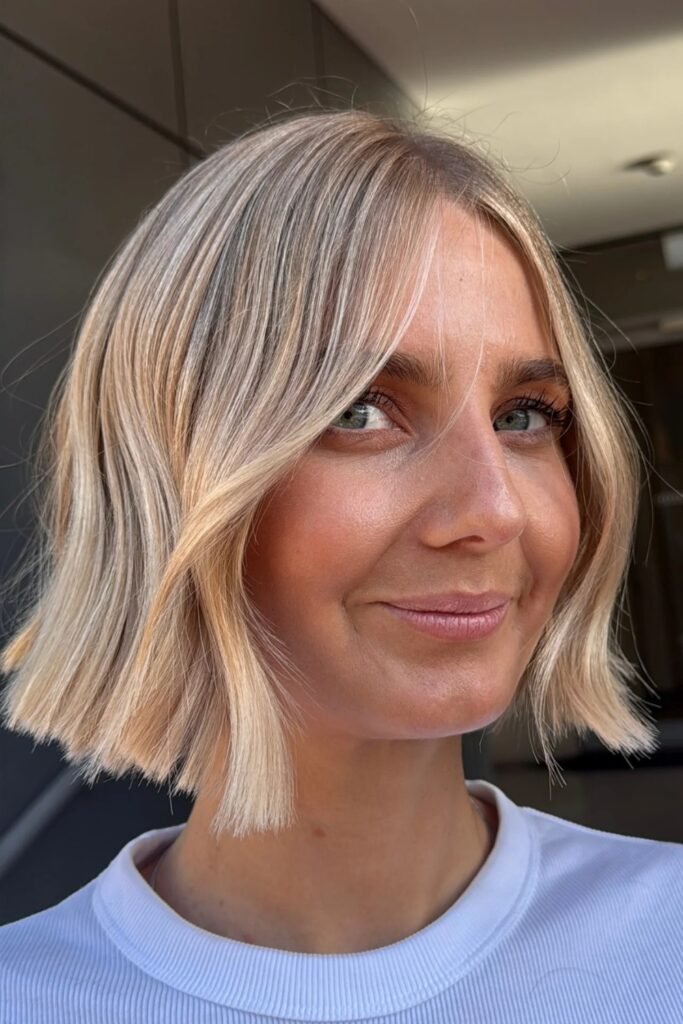 Wavy blonde Scandi bob with a middle parting