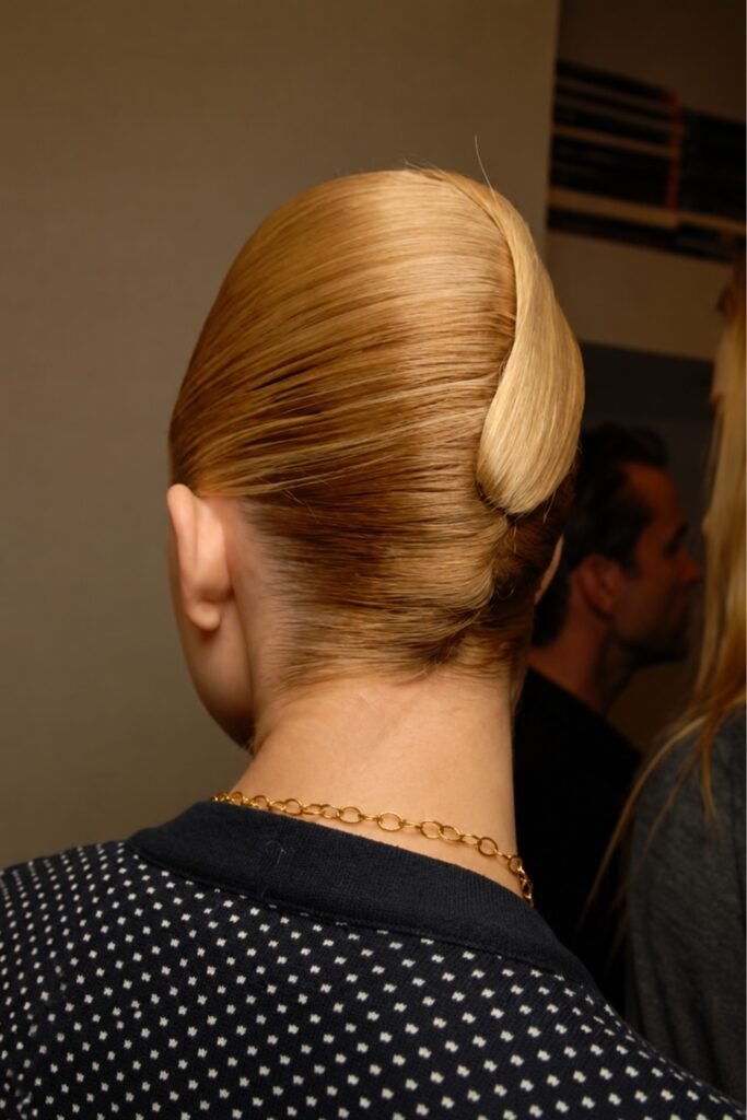 Back view of blonde hair in a sleek sculpted French twist
