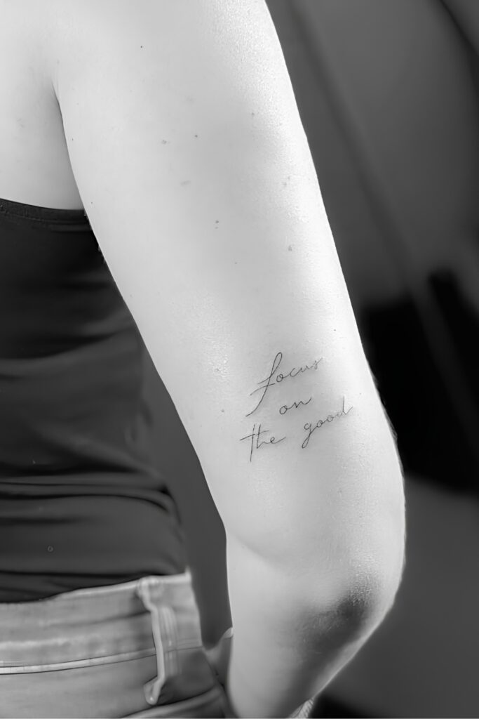 Short vertical script tattoo