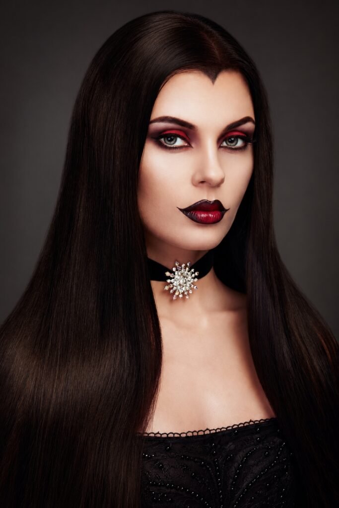 Long sleek dark hair with a sharp center part and deep red lips