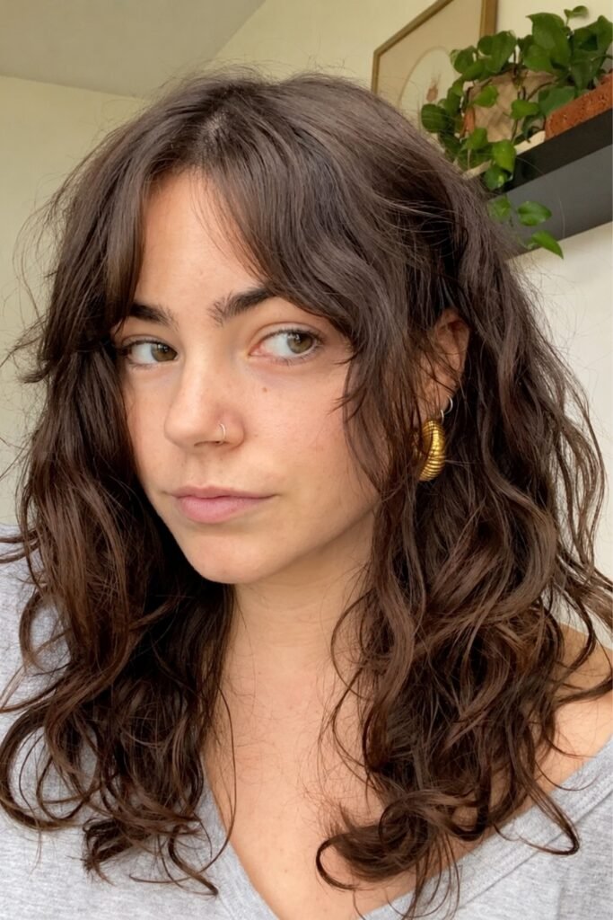Wavy brunette layers with a curtain fringe
