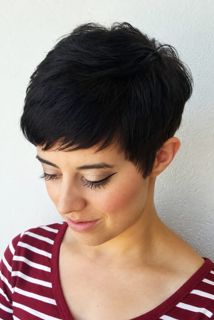 Woman with a thick tapered pixie, looking down