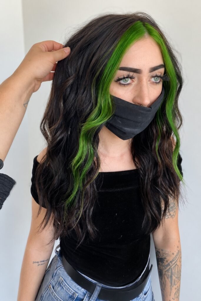 Dark wavy hair with bright green front sections