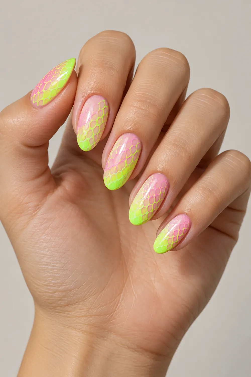 Baby pink and neon lime nails with snake-scale pattern