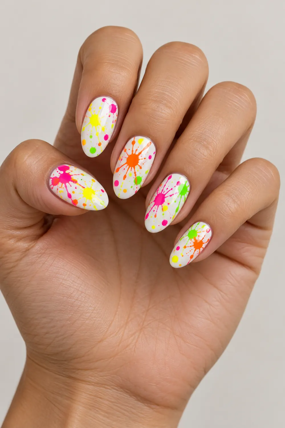 White nails with colorful neon paint splatters