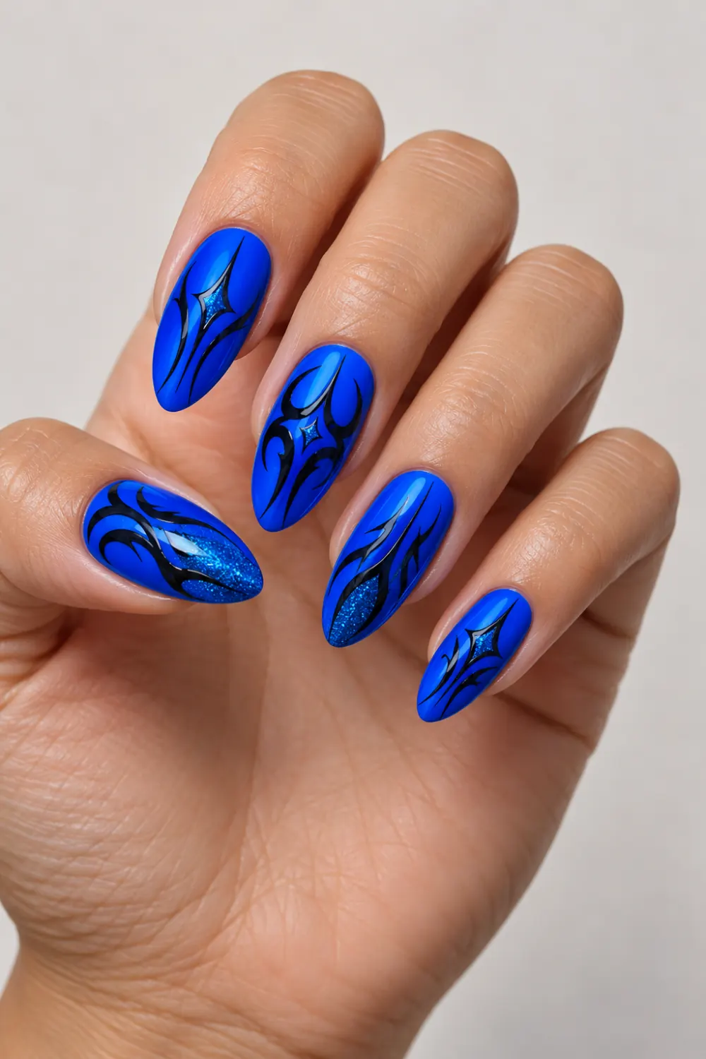 Electric blue neon nails with tribal lines and glitter accents