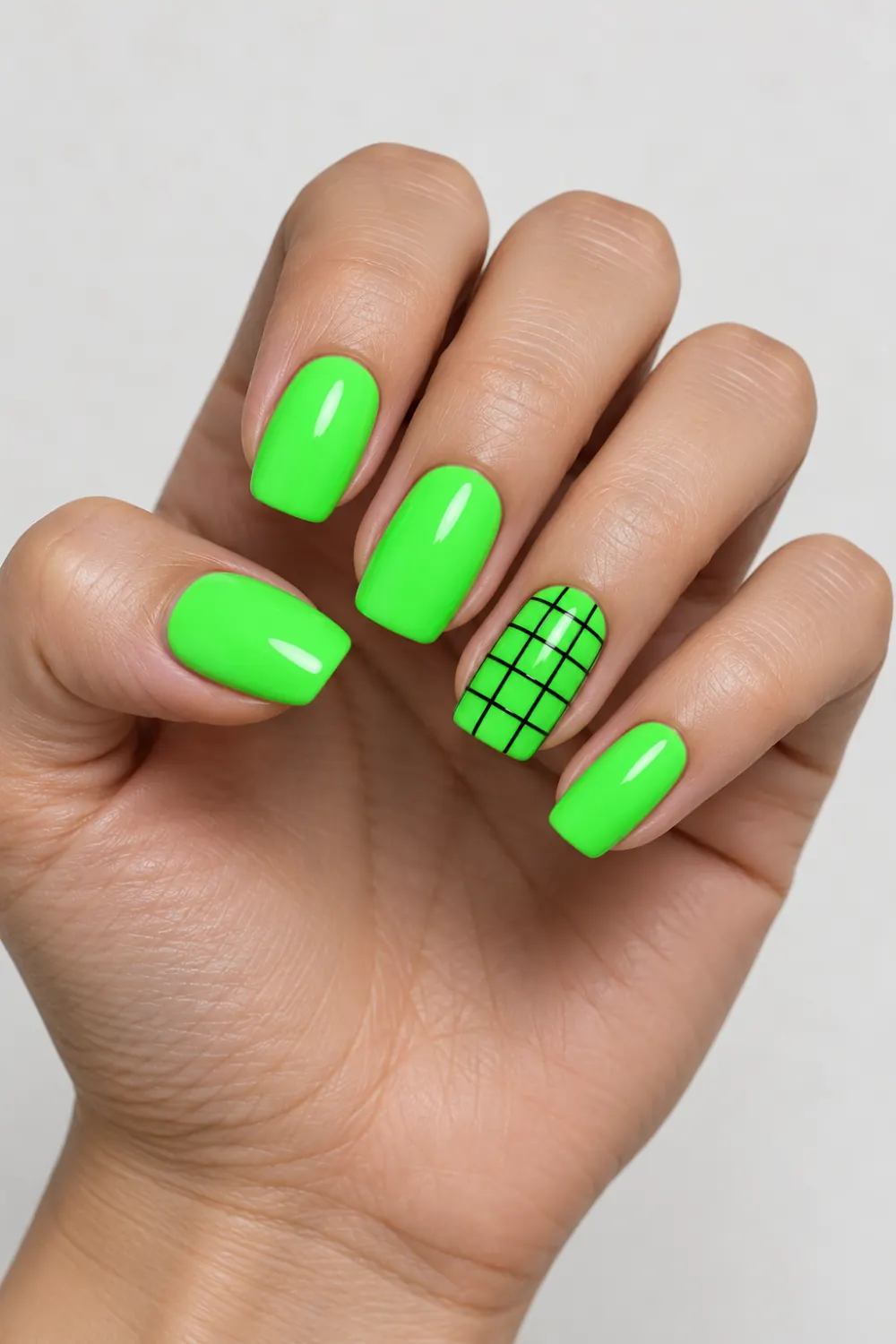 Neon green nails with a black matrix-grid accent nail